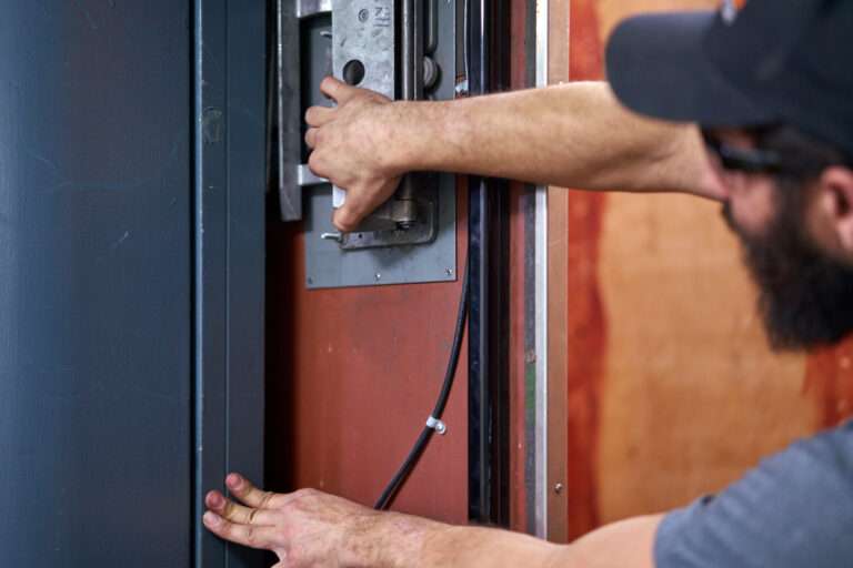 Icon Maintenance technician adjusting elevator door